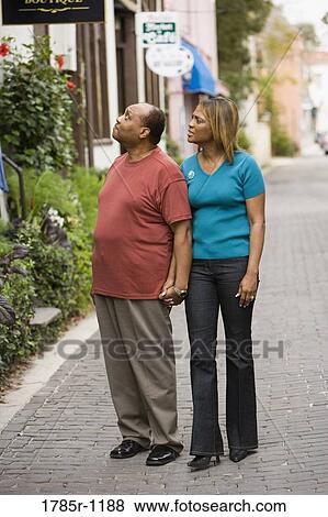 Stock Photo - Mature African American couple walking and gazing. Fotosearch