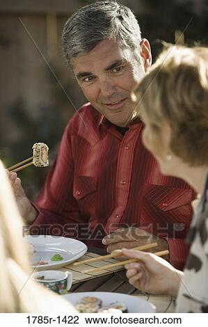 Mature couple eating sushi View Large Photo Image Stock Image - Mature couple eating sushi. Fotosearch