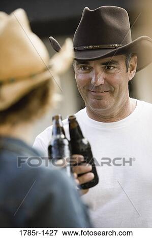 Mature couple in country clothes having a beer View Large Photo Image Stock Photo - Mature couple in country clothes having a beer. Fotosearch