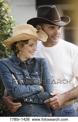 Stock Photograph - Mature couple in country clothes standing together. Fotosearch