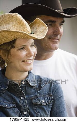 Stock Photography - Mature couple in country clothes standing together. Fotosearch