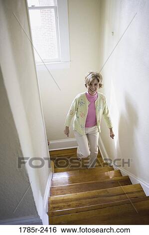 Mature woman climbing stairs View Large Photo Image Stock Photograph - Mature woman climbing stairs. Fotosearch
