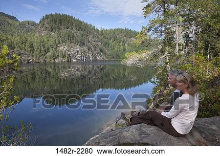 Mid adult couple looking at lake view, Cassel Lake, Teakerne Arm Provincial Park, British Columbia, Canada View Large Photo Image Stock Image - Mid adult couple looking at lake view, Cassel Lake, Teakerne Arm Provincial Park, British Columbia, Canada. Fotosearch