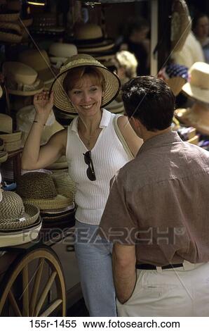 Mid adult couple shopping for hats View Large Photo Image Stock Photography - Mid adult couple shopping for hats. Fotosearch