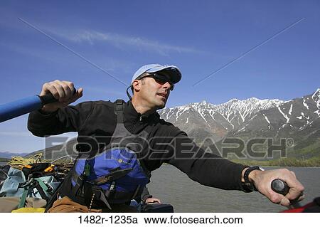 Mid adult man rafting in the river, Dezadeash River, Yukon, Canada View Large Photo Image Stock Image - Mid adult man rafting in the river, Dezadeash River, Yukon, Canada. Fotosearch