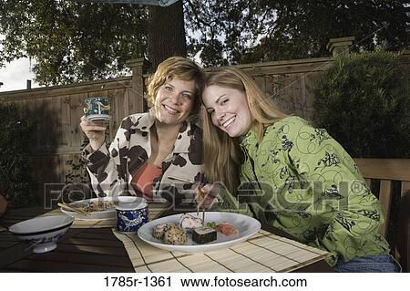 Mother and daughter eating sushi together View Large Photo Image Stock Image - Mother and daughter eating sushi together. Fotosearch