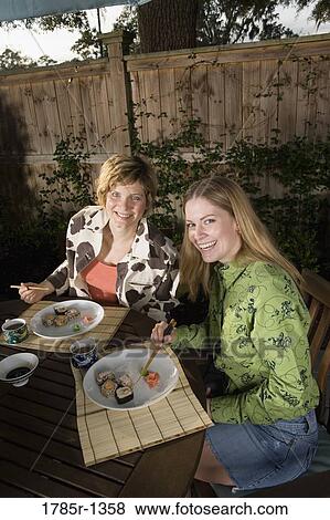 Mother and daughter eating sushi View Large Photo Image Stock Photo - Mother and daughter eating sushi. Fotosearch