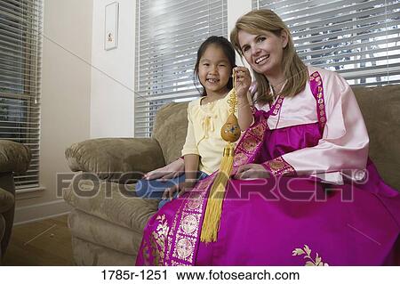 Mother and daughter in living room, mother wearing a Hanbok View Large Photo Image Stock Image - Mother and daughter in living room, mother wearing a Hanbok. Fotosearch