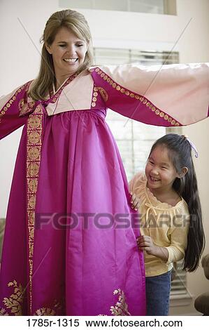 Mother and daughter in living room, mother wearing a Hanbok View Large Photo Image Stock Photography - Mother and daughter in living room, mother wearing a Hanbok. Fotosearch