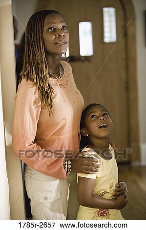 Mother and daughter looking inside house View Large Photo Image Stock Photo - Mother and daughter looking inside house. Fotosearch