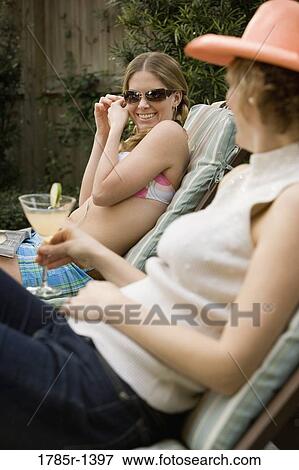 Mother and daughter relaxing on deck chairs View Large Photo Image Stock Photo - Mother and daughter relaxing on deck chairs. Fotosearch