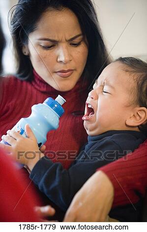 Mother holding crying little boy View Large Photo Image Stock Photo - Mother holding crying little boy. Fotosearch