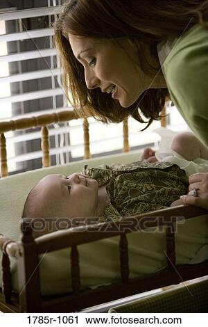 Mother with baby on diaper changing table View Large Photo Image Stock Image - Mother with baby on diaper changing table. Fotosearch