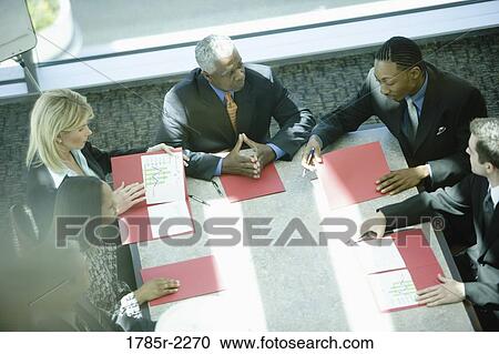 Overhead view of business colleagues in a meeting View Large Photo Image Stock Image - Overhead view of business colleagues in a meeting. Fotosearch