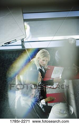 Overhead view of business colleagues in a meeting View Large Photo Image Stock Image - Overhead view of business colleagues in a meeting. Fotosearch