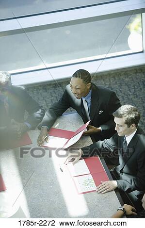 Overhead view of business colleagues in a meeting View Large Photo Image Stock Image - Overhead view of business colleagues in a meeting. Fotosearch