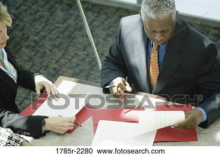 Overhead view of business colleagues in a meeting View Large Photo Image Stock Image - Overhead view of business colleagues in a meeting. Fotosearch