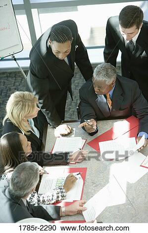 Overhead view of business colleagues in a meeting View Large Photo Image Stock Image - Overhead view of business colleagues in a meeting. Fotosearch