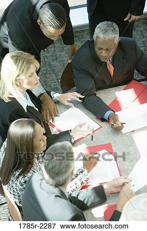 Overhead view of business colleagues in a meeting View Large Photo Image Stock Photo - Overhead view of business colleagues in a meeting. Fotosearch
