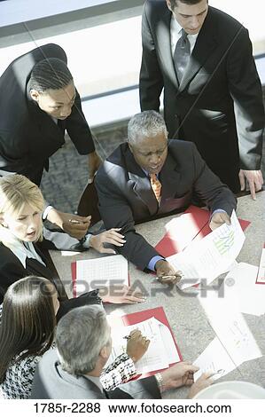 Overhead view of business colleagues in a meeting View Large Photo Image Stock Photo - Overhead view of business colleagues in a meeting. Fotosearch