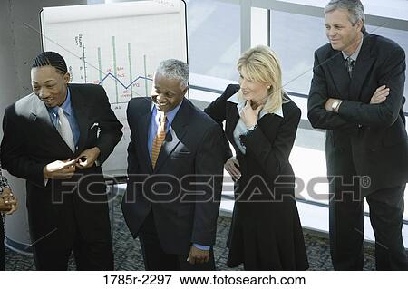 Stock Photo - Overhead view of business colleagues in a meeting. Fotosearch