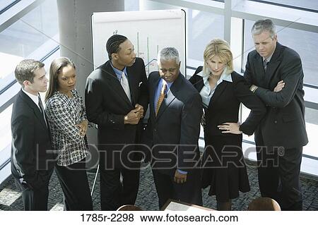 Overhead view of business colleagues in a meeting View Large Photo Image Stock Photo - Overhead view of business colleagues in a meeting. Fotosearch