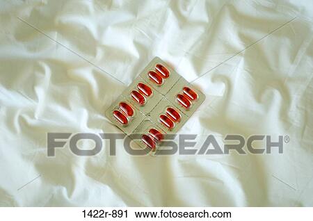 Package of medicine capsules on white bed sheet View Large Photo Image Stock Image - Package of medicine capsules on white bed sheet. Fotosearch