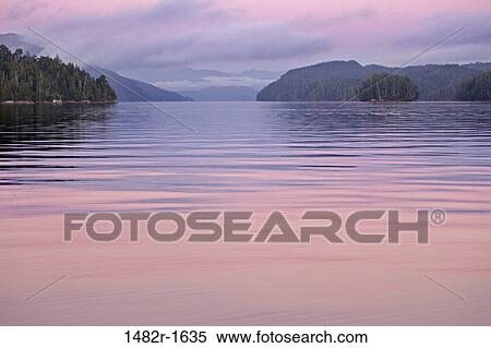 Panoramic view of the sea with a mountain range in the background, Calvert Island, British Columbia, Canada View Large Photo Image Stock Photography - Panoramic view of the sea with a mountain range in the background, Calvert Island, British Columbia, Canada. Fotosearch