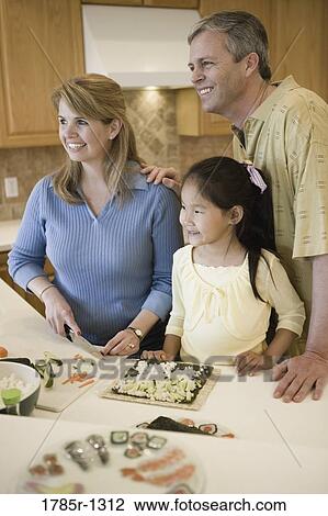 Parents and adopted Asian daughter making sushi View Large Photo Image Stock Image - Parents and adopted Asian daughter making sushi. Fotosearch
