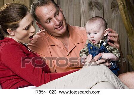 Parents playing with baby in backyard View Large Photo Image Stock Image - Parents playing with baby in backyard. Fotosearch