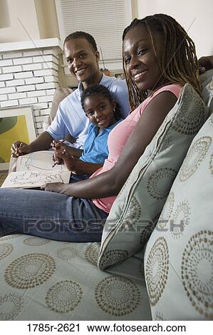 Parents reading and coloring with daughter View Large Photo Image Stock Image - Parents reading and coloring with daughter. Fotosearch