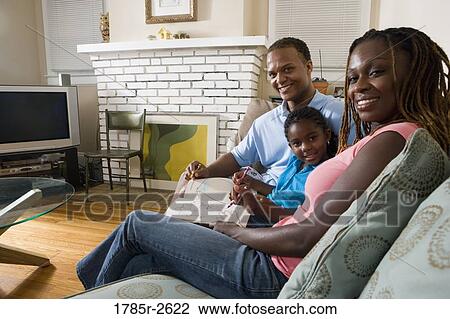Parents reading and coloring with daughter View Large Photo Image Stock Image - Parents reading and coloring with daughter. Fotosearch