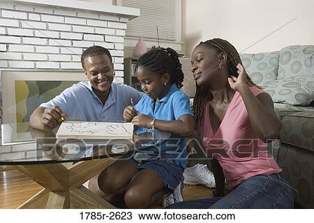 Parents reading and coloring with daughter View Large Photo Image Stock Image - Parents reading and coloring with daughter. Fotosearch