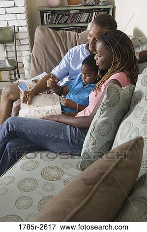 Parents reading and coloring with daughter View Large Photo Image Stock Photo - Parents reading and coloring with daughter. Fotosearch