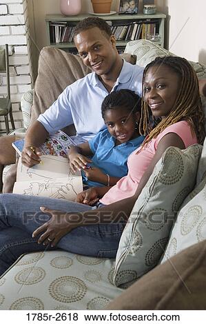 Parents reading and coloring with daughter View Large Photo Image Stock Photo - Parents reading and coloring with daughter. Fotosearch