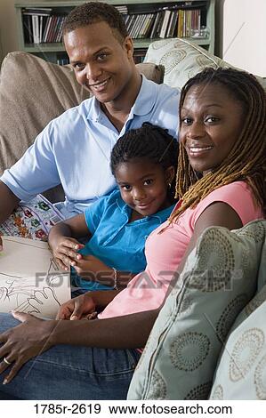 Parents reading and coloring with daughter View Large Photo Image Stock Photo - Parents reading and coloring with daughter. Fotosearch