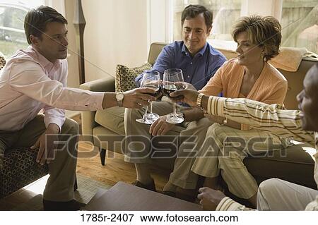 Parents toasting with adult son and friend View Large Photo Image Stock Photo - Parents toasting with adult son and friend. Fotosearch