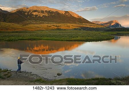 Person fly-fishing at the riverside, Green River, Bridger-Teton National Forest, Wyoming, USA View Large Photo Image Stock Image - Person fly-fishing at the riverside, Green River, Bridger-Teton National Forest, Wyoming, USA. Fotosearch