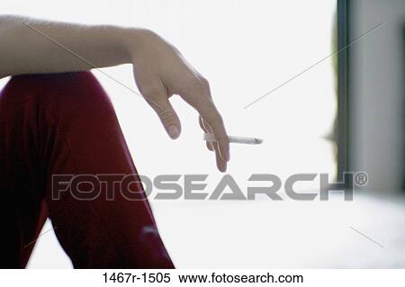 Person holding a cigarette View Large Photo Image Stock Photography - Person holding a cigarette. Fotosearch
