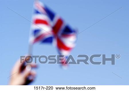 Person holding a flag of the United Kingdom View Large Photo Image Stock Image - Person holding a flag of the United Kingdom. Fotosearch