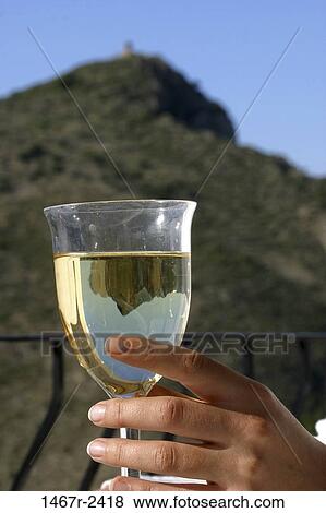 Stock Photo - Person holding a glass of wine. Fotosearch
