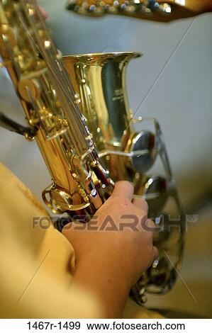 Stock Photo - Person playing the saxophone. Fotosearch