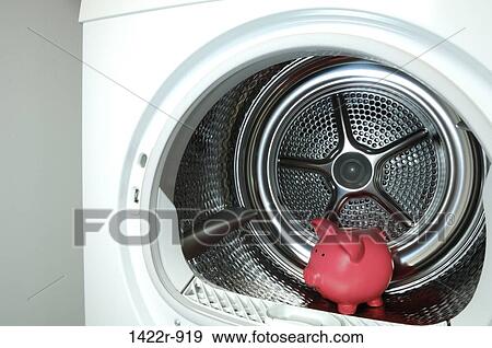 Stock Photo - Pink piggybank inside laundry tumble dryer. Fotosearch