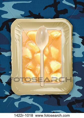 Plastic package of food with utensils on a camouflage background View Large Photo Image Stock Photo - Plastic package of food with utensils on a camouflage background. Fotosearch
