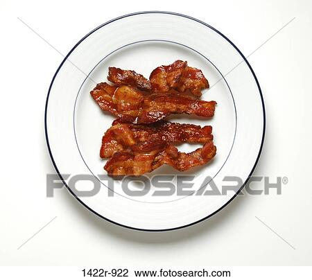 Stock Image - Plate with four slices of cooked bacon. Fotosearch