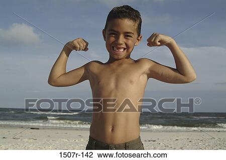 Portrait of a boy flexing his biceps at the beach View Large Photo Image Stock Image - Portrait of a boy flexing his biceps at the beach. Fotosearch