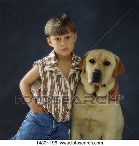 Portrait of a boy holding a dog View Large Photo Image Stock Photograph - Portrait of a boy holding a dog. Fotosearch