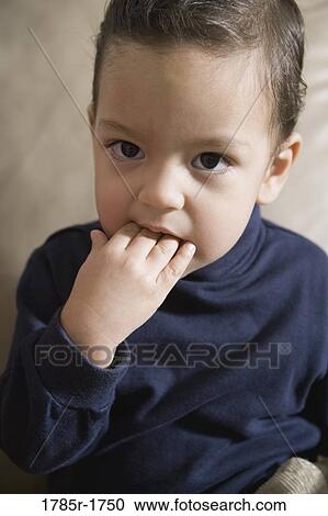 Portrait of a boy sucking his fingers View Large Photo Image Stock Image - Portrait of a boy sucking his fingers. Fotosearch