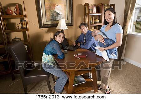 Portrait of a cheerful Asian-Caucasian family in the study of their home View Large Photo Image Stock Image - Portrait of a cheerful Asian-Caucasian family in the study of their home. Fotosearch