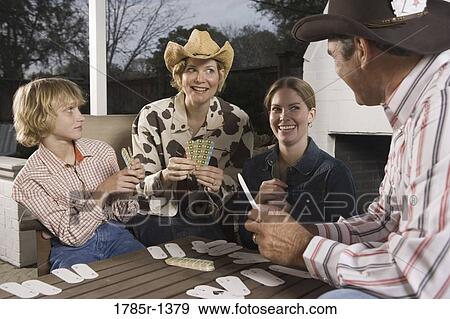 Stock Photo - Portrait of a country family playing card game. Fotosearch
